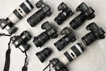 Wall Mural - modern cameras on gray marble table, flat lay