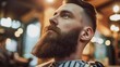 bearded man in a barbershop cutting his hair