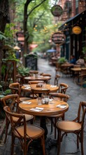 Cozy Outdoor Cafe Setting With Wooden Chairs And Tables On A City Sidewalk