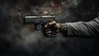 Hand holding gun on blurred gray background with text space, criminality, violence concept.