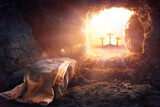 Fototapeta Natura - Resurrection Of Jesus Christ  - Empty Tomb -  Focus On Shroud And Defocused Crosses On Background With flare Lights Effects