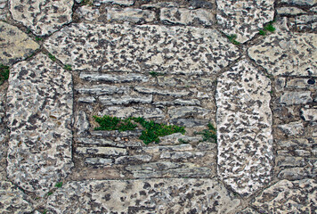 Wall Mural - Close-up view of typical cobblestone in small mountain village Erice, Sicily, Italy. Medieval stone street. Stone pattern, cobblestone texture. Background of stone pathway texture.