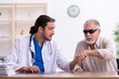 © Elnur - Old blind man visiting young male doctor