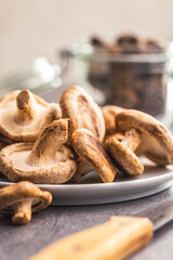 Wall Mural - The fresh shiitake mashrooms on plate on kitchen table.