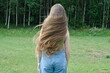 © Volha - young woman with very long brown hair with forest on background