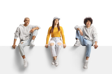 Canvas Print - Generation z young people sitting on a blank panel