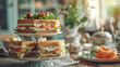 old fashioned tea shop on table, salmon and cucumber sandwiches with cake on a cake stand. two people sitting at the table