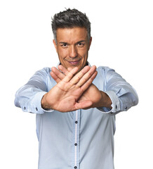 Middle-aged Latino man doing a denial gesture