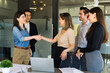 Pair of businesswomen shaking hands in a meeting room