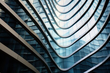 Modern Tall City Building With Wavy Futuristic Design, Low Angle View Of Abstract Curve Lines. Geometric Facade With Glass And Steel. Concept Of Architecture Exterior, Office