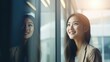 © Krtola  - Asian young business woman looking at the window