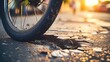 Macro view of a bicycle tire navigating through city potholes and cracks.