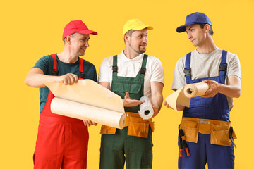 Sticker - Team of male builders with wallpapers on yellow background