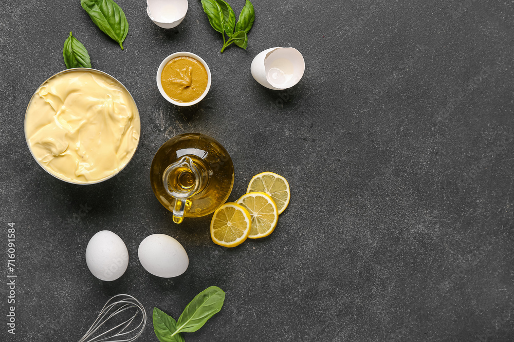 Bowl of fresh mayonnaise and ingredients on black background