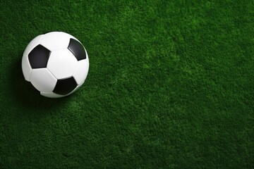 Top view of soccer ball on green artificial grass field