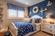 Nautical themed kids' room with navy blue accents, seaside decor, star-patterned bedspread, and windows