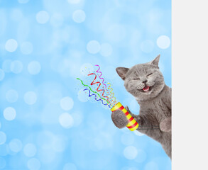 Aufkleber - Happy cat holds exploding firecracker and looks from behind empty white banner. Festive blue blured background