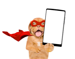 Aufkleber - Happy Mastiff puppy wearing superhero costume shows big smartphone with white blank screen in it paw. Isolated on white background