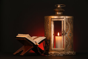 Wall Mural - Muslim lamp and rehal with Koran for Ramadan on table against dark red background