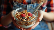 Woman holding bowl of cereal and spoon. Great for breakfast or healthy eating concepts