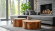 © sirisakboakaew - Close-up of a coffee table with two tree stumps near a gray sofa beside a window and fireplace.