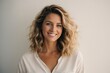 © VistaVisions - Portrait of young happy white caucasian woman smiling standing in front of blank white wall looks in camera generative ai