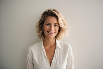 Portrait of young happy white caucasian woman smiling standing in front of blank white wall looks in camera generative ai