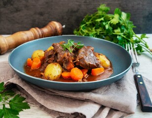 Wall Mural - Beef meat stewed with potatoes-Traditional French cuisine Beef Bourguignon potatoes carrots in persillade