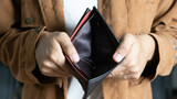 Fototapeta  - Poor man bankrupt with no credit in debt hand hold empty black leather wallet because economy down turn Empty wallet (no money) in the hands of an man