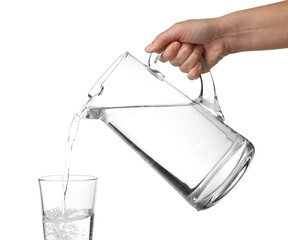 Wall Mural - Woman pouring water from jug into glass on white background, closeup