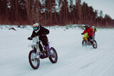 Fototapeta Sport - Winter motocross. Racers ride on ice. Winter sports.