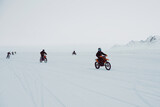 Fototapeta Sport - Winter motocross. Racers ride on ice. Winter sports.