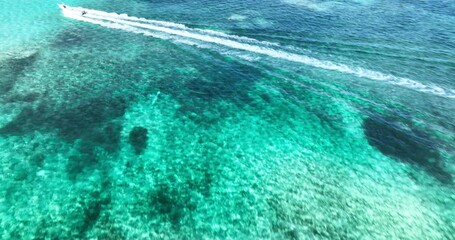 Wall Mural - Aerial panorama view of reefs and pools in caribbean sea and sail speed boat in the water 4k video