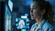© Ekayuth - Confident Female Neurologist, Neuroscientist, Neurosurgeon, Looks at TV Screen with MRI Scan with Brain Images, Thinks about Sick Patient Treatment Method. Saving Lives, Medical Science Hospital