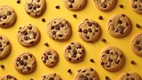 Fototapeta Góry - Pattern of chocolate chip cookies scattered on a isolate yellow background