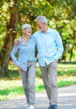 Fototapeta Łazienka - woman man senior couple happy retirement together elderly active vitality park fun smiling love old nature wife happiness mature walking holding hands