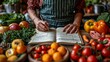 Balanced choices: Surrounded by fruits and veggies, a person jots down notes, actively creating a diverse and nourishing diet plan in a notebook.