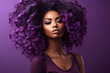 Beautiful african american woman with afro hairstyle and makeup on purple background