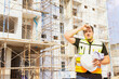 © ฺฺฺBoonterm - Foreman working outdoors condominium construction project exhausted from the hot weather and thirsty tired dizzy headache is dehydrated and wants to drink water suffer dehydration heatstroke.