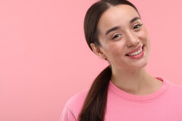 Poster - Beautiful woman with clean teeth smiling on pink background, space for text