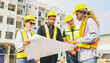 © ฺฺฺBoonterm - Team architects multi ethnic workers men and women meeting brainstorming construction of condominium buildings civil engineers examining blueprints giving advice planning projects housing real estate.