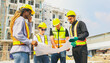 © ฺฺฺBoonterm - Team architects multi ethnic workers men and women meeting brainstorming construction of condominium buildings civil engineers examining blueprints giving advice planning projects housing real estate.