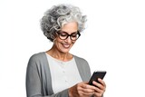 Fototapeta Uliczki - Smiling mature woman with a smartphone isolated on a white background