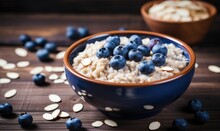 Oatmeal Porridge With Fresh Blueberries And Almonds In A Bowl On Wooden Table. Healthy Breakfast Concept