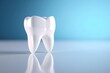 White tooth on blue background, light emphasizes the purity of the tooth
