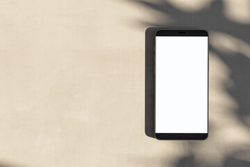 Poster - Close up of empty white cellphone on light surface with leaf shadows. Presentation concept. Mock up, 3D Rendering.
