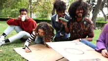 Activists In The Park Preparing Their Cardboard Signs Against War And For Peace And Equality