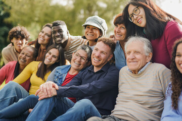 group of multiracial people with different ages having fun together at city park - community and soc