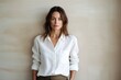 © CogniLens - Portrait of a tender woman in her 40s wearing a simple cotton shirt against a modern minimalist interior. AI Generation