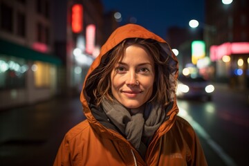 Wall Mural - Portrait of a glad woman in her 40s wearing a functional windbreaker against a bustling city street at night. AI Generation